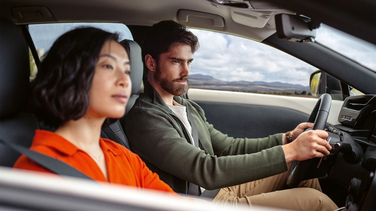 A woman and man sat in a Lexus RZ 450e