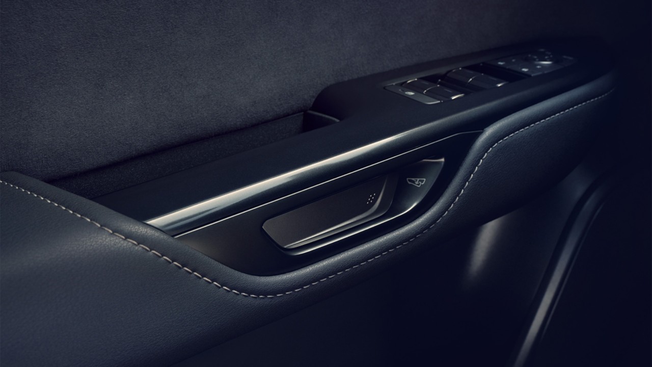 The Safe Exit Assist button within the Lexus RZ 450e door handle 