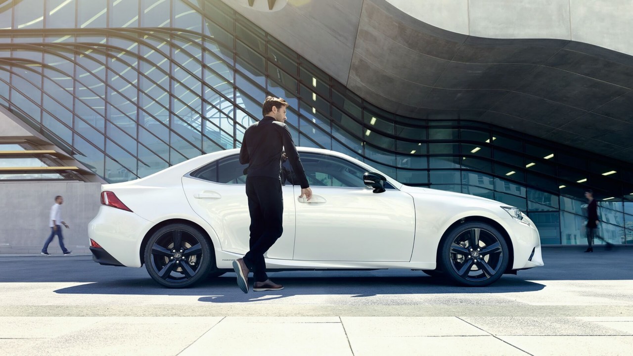 A man opening the door of a Lexus LS